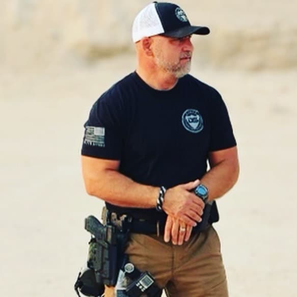 instructor addressing the CCW class on the range between two targets