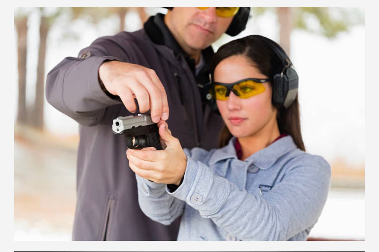 Female training with instructor using red dot